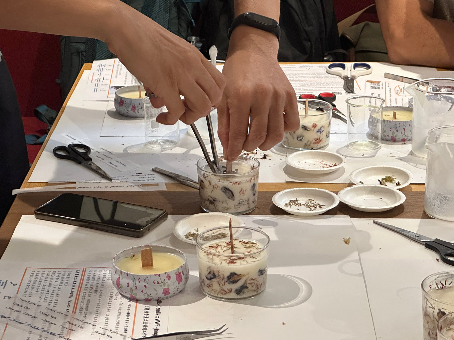 Hands-on candle-making workshop with students learning artistic techniques.