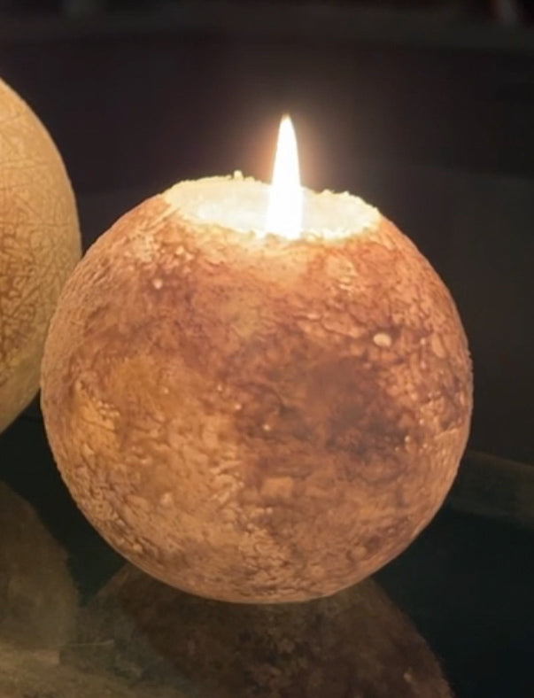 Snowball Candle emitting a warm glow with a tealight, enhancing holiday ambiance.